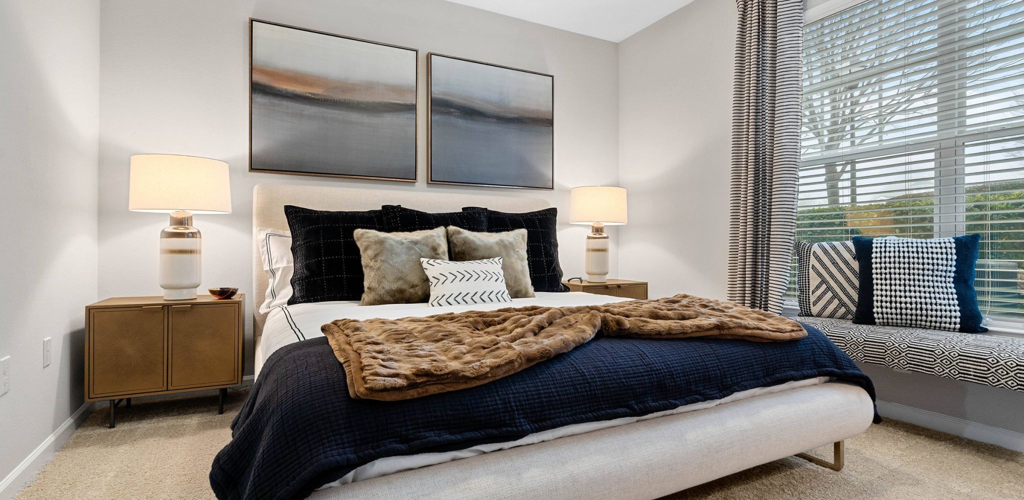 Hawthorne at the Greene spacious apartment bedroom with a large bed, two side tables, a large window, and carpeted floor